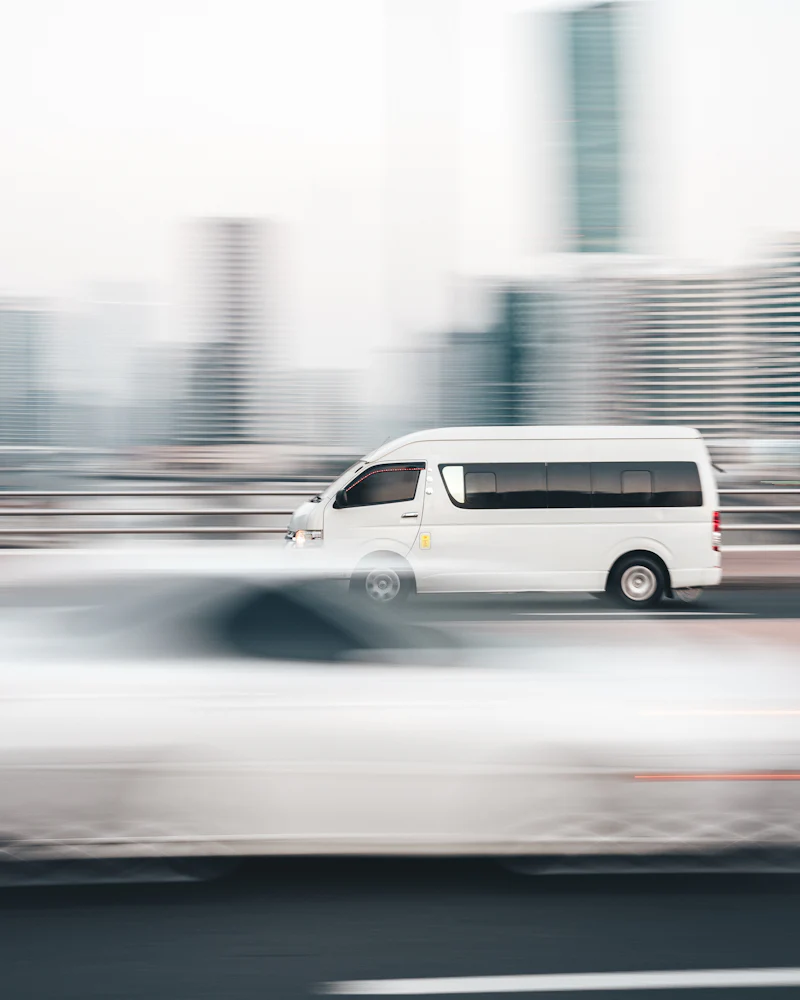 White van moving fast along a highway