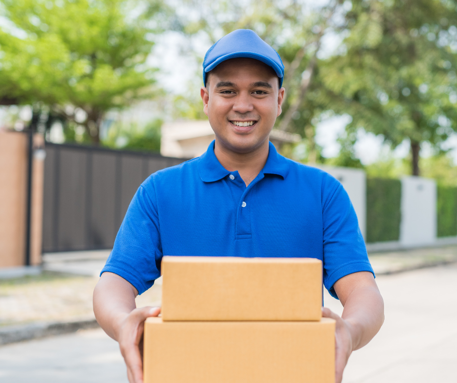 Smiling delivery man in uniform holding a box, representing Document Delivery Service Singapore.